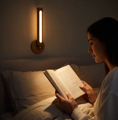 Rechargeable wooden LED wall lamp standing vertically on magnetic base with warm glow