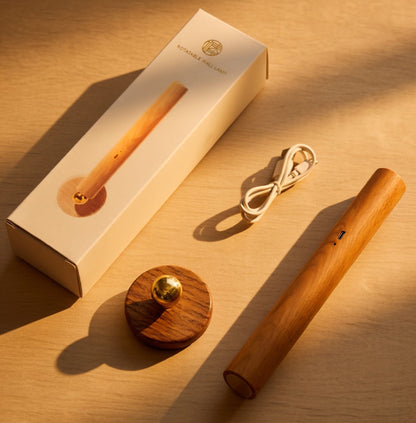 Magnetic wooden wall lamp with packaging base and charging cable on wooden surface